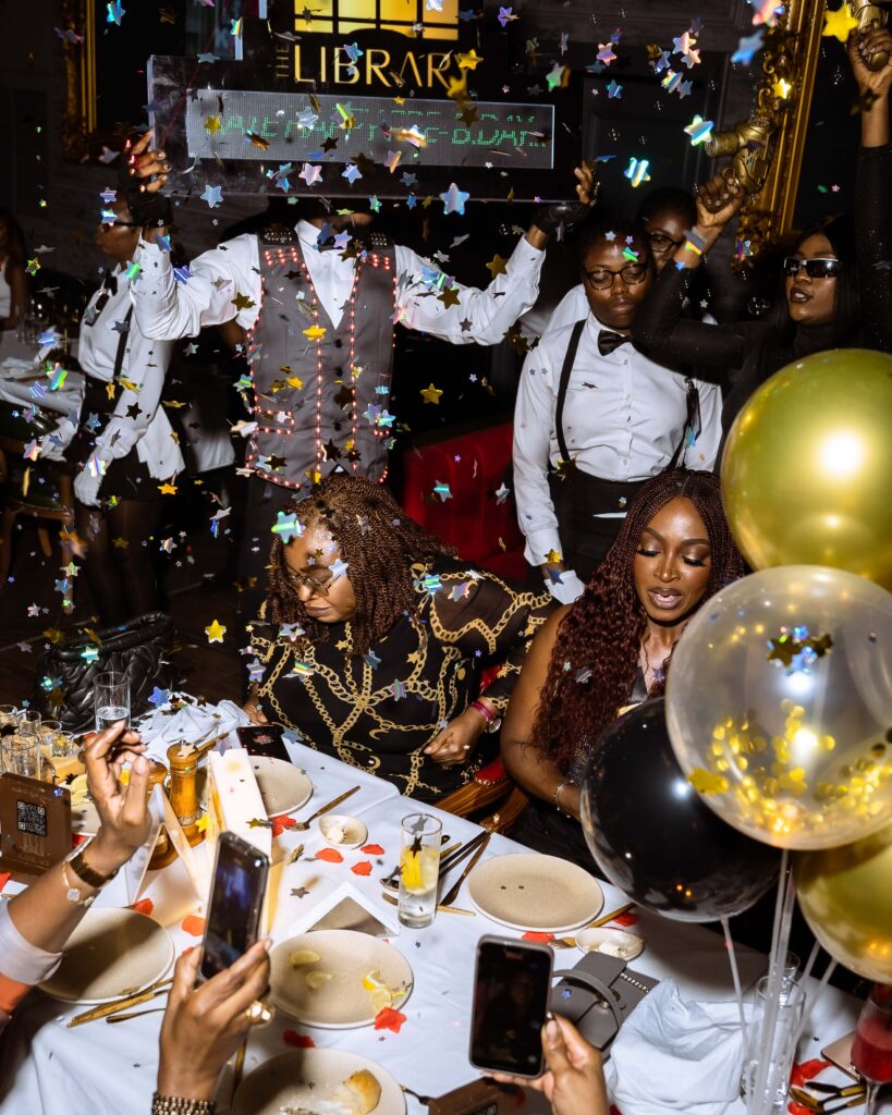 Nigerian celebrity Kate Henshaw celebrating her birthday at Cee 4 Arena Owerri, surrounded by loved ones, balloons, sparkles, and confetti in a lively, elegant setting
